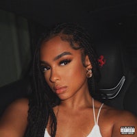 a woman in a car with braided hair