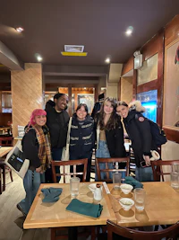 a group of people posing for a picture in a restaurant