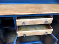 a blue dresser with drawers on it