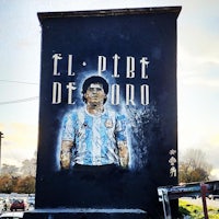 a painting of a soccer player on the side of a building