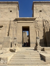 egyptian temple with carvings on the side of the building