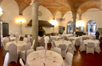 a banquet room with white tables and chairs