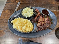 a plate with meat, macaroni and cheese