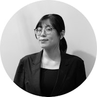 a black and white photo of a woman wearing glasses