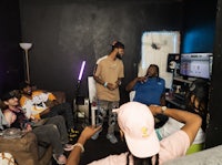 a group of people sitting in a room watching tv