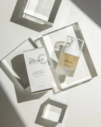 a bottle of skin care products on a white surface