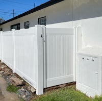 a white fence in front of a house