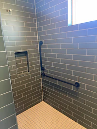a bathroom with a tiled floor and a skylight
