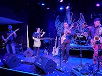 a group of musicians on stage at a concert