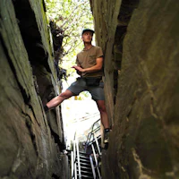 a man standing in a narrow passageway