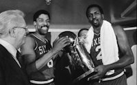 philadelphia 76ers player person holds the nba championship trophy
