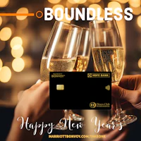 two people toasting champagne glasses with the words boundless happy new year