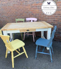 a table and chairs painted in a variety of colors