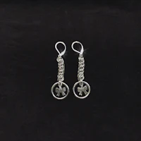 a pair of silver earrings with a heart on them