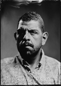 a black and white photo of a man with a beard