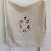 a tote bag with embroidered flowers on it