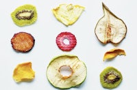 a variety of fruits and vegetables are arranged on a white surface