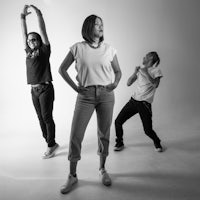 a black and white photo of a group of people dancing