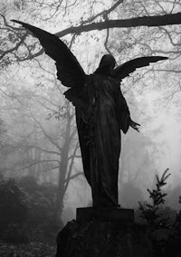 a statue of an angel in the fog