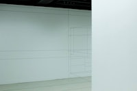 a white room with a drawing on the wall