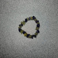 a bracelet with purple, yellow and green stones