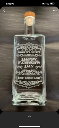 a glass bottle with a happy father's day message on it