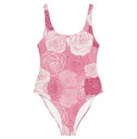 a pink one piece swimsuit with roses on it