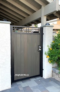 a wooden gate with a black metal frame