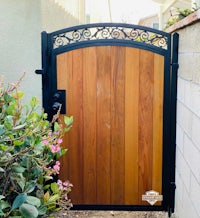 a wooden gate in front of a house