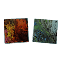 two colorful marble coasters on a black background