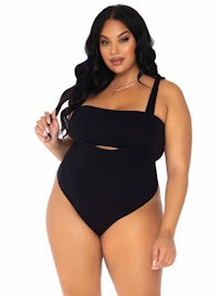 a plus size woman wearing a black one piece swimsuit