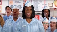 a group of people in blue uniforms singing a song