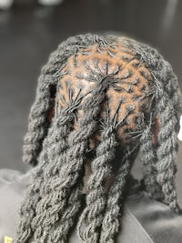 the back of a person's head with dreadlocks
