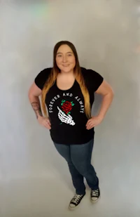 a woman wearing a black t - shirt with a rose on it