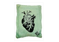 a green pillow with an image of a heart
