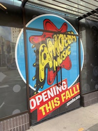 a storefront with a sign that says amusement music opening this fall