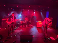 a group of people playing music in a dark room