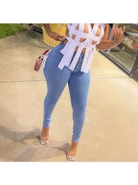 a woman in a white top and blue jeans
