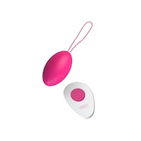 a pink and white sex toy next to a white button