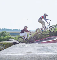 a group of people riding bikes in a park