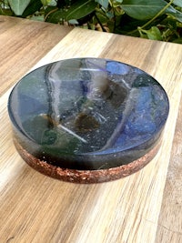 a round piece of stone sitting on top of a wooden table