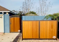 a wooden fence in front of a house