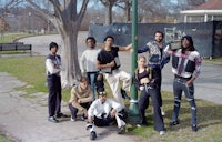 a group of people posing for a photo in a park