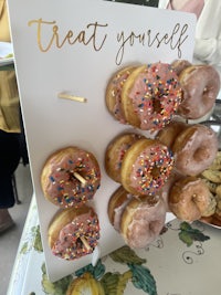 a tray of donuts with sprinkles on it