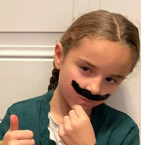 a girl with a mustache on her face giving a thumbs up
