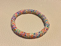a bracelet with multi colored beads on it