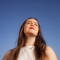 a young woman looking up at the sky