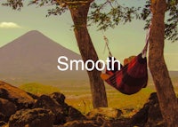 a person in a hammock in front of a mountain