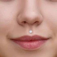 a woman's face with a nose piercing