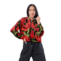 a woman wearing black pants and a jacket with red roses on it